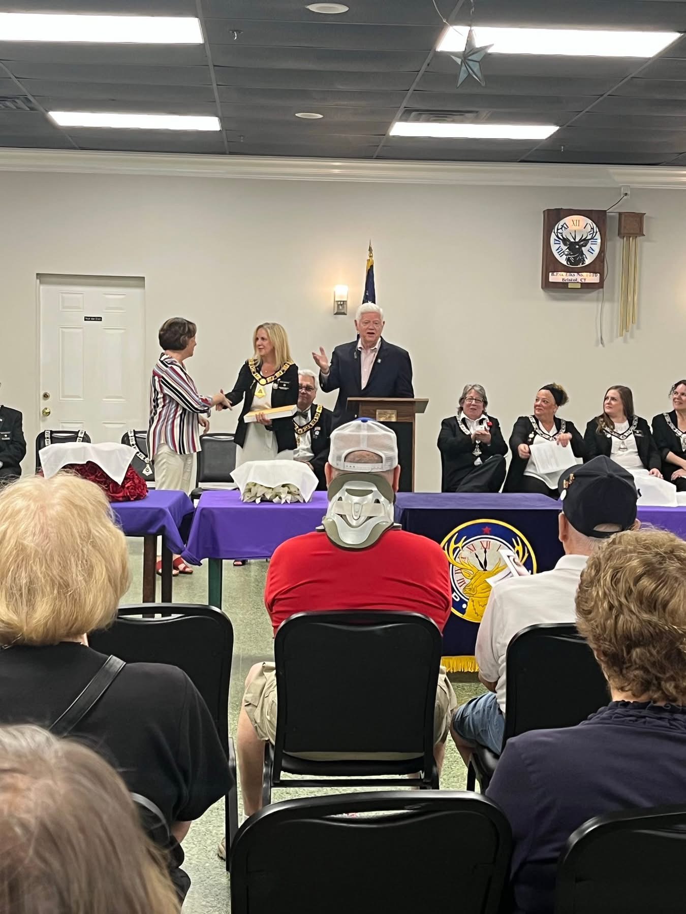 Congressman John Larson and Mayor Ellen Zoppo-Sassu presenting the Capitol flag to Exalted Ruler Caroline Martin